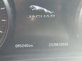 a close up of a car dashboard with a jaguar logo on it