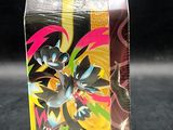 the box has a small figure inside of it on a black surface