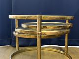 a set of three brass and glass nesting tables