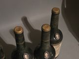 several bottles of wine are lined up on a counter top