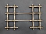a pair of antique silver plated metal racks with handles