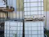 two white containers stacked on top of each other in the grass