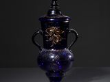 a blue vase with a dragon on it on a table