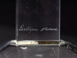 a close up of a bottle of perfume sitting on top of a table