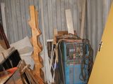 a yellow door in the middle of a room with a lot of junk