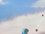 many balloons that are flying in the sky on a cloudy day