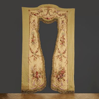 a yellow and red embroidered curtain hanging on a wall