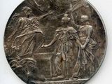 une vieille pièce d'argent sur laquelle sont représentés une femme et un homme