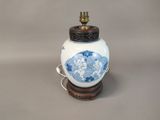 an image of a blue and white vase sitting on a wooden stand