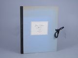 a blue book with a black ribbon on it
