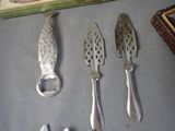 three knives and a bottle opener sitting on a table