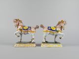 pair of porcelain figurines of a horse and rider on a green base