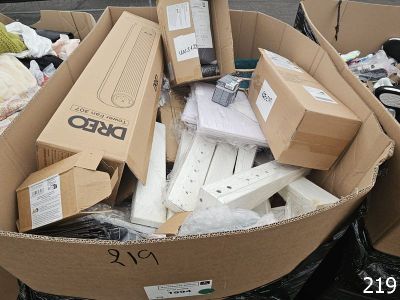 many boxes of electronic devices in a pile on the street