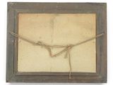 an old picture frame with a rope wrapped around it on a white background