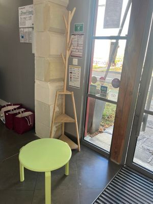 a small green table in the corner of a room