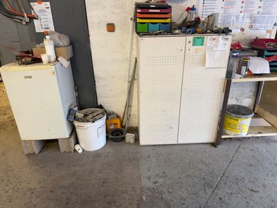 a refrigerator and a refrigerator freezer in a garage