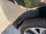 a close up of a car ' s tire with a person standing next to it