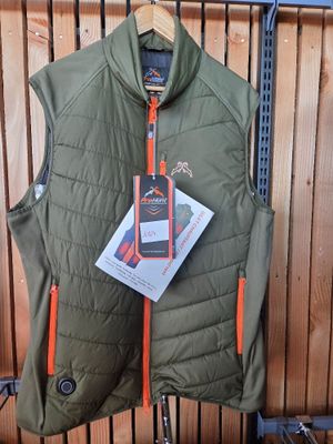 a green vest with orange zippers hanging on a rack