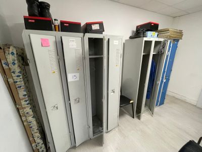 several metal lockers are lined up in a row in a room