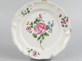 a white plate with a pink rose and blue flowers on it