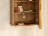 a wooden medicine cabinet with a mirror above it