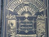 an old book sitting on top of a table covered in pictures