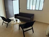 a living room with a couch, chair, and coffee table