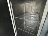 an open refrigerator with a metal door in a room
