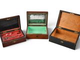 three wooden boxes that are open on a white surface