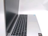 a silver laptop with a black keyboard on a white surface