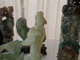 a lot of jade figurines sitting on a table