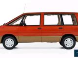 a small orange van that is parked on the side of the road