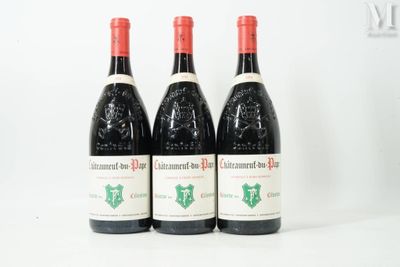 three bottles of red wine sitting on top of a white table