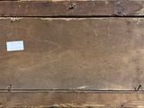 an old wooden picture frame with a sticker on top of it
