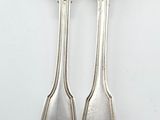 two spoons and a fork on a white surface