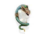 a close up of a snake ' s head with a pearl in it ' s mouth