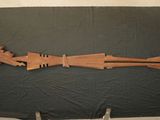 a wooden sculpture of a man with a gun on a table