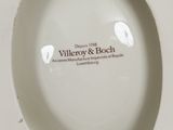a white porcelain plate with a logo on it