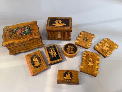 several small wooden boxes with pictures of people and flowers on them