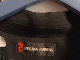 a black shirt hanging on a hanger on a wall