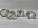 three empty glass jars sitting on a white surface