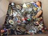 a box full of assorted key chains and other items