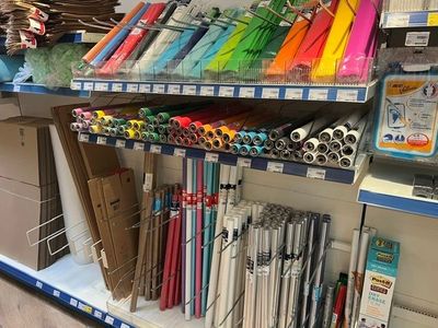 many different colors of umbrellas on the shelves in the store