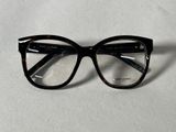 a pair of glasses sitting on a white surface