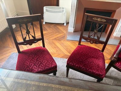 two red chairs sitting next to each other on the floor