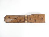 brown ostrich leather belt with gold buckle on a white background