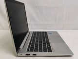 an open laptop computer sitting on top of a white surface