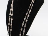 a close up of a necklace on a mannequin display