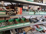 many different types of screws and nuts on the shelves