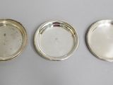 three silver trays on a table with one empty and one empty